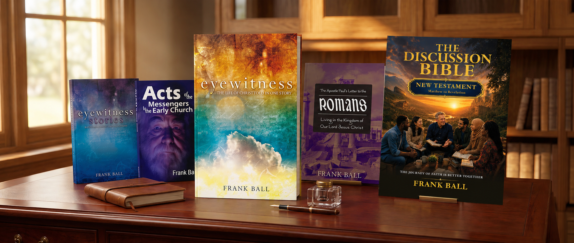A collection of Frank Ball’s books on a wooden desk